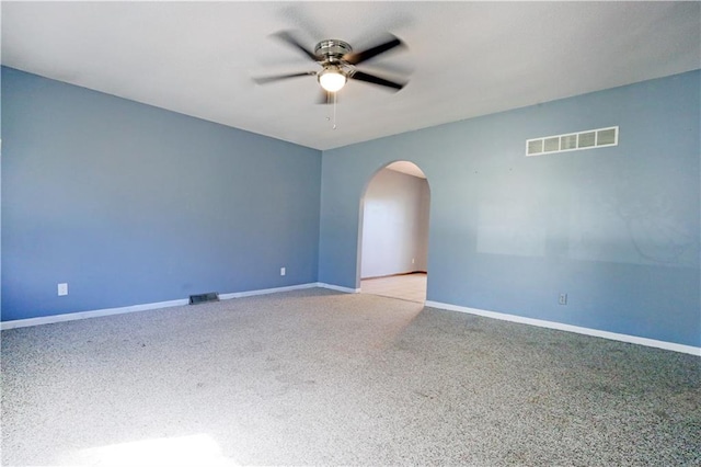 carpeted spare room with ceiling fan