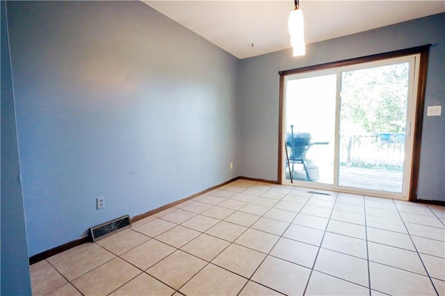 spare room featuring a wealth of natural light and light tile patterned floors