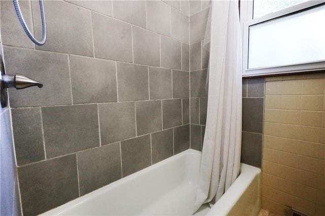 bathroom with shower / bath combo with shower curtain