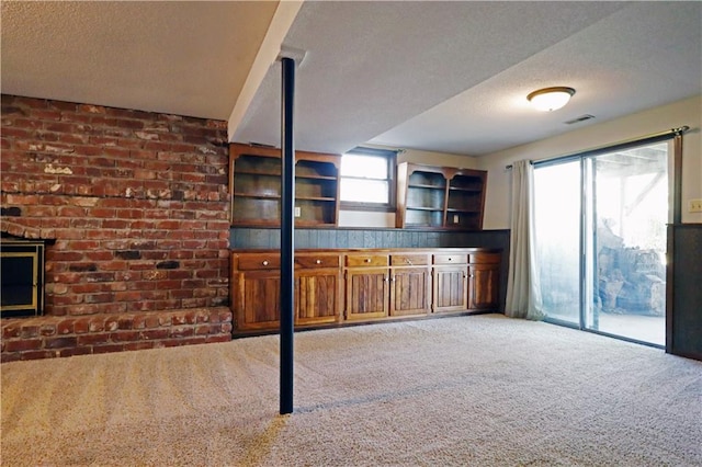 kitchen with a textured ceiling and carpet