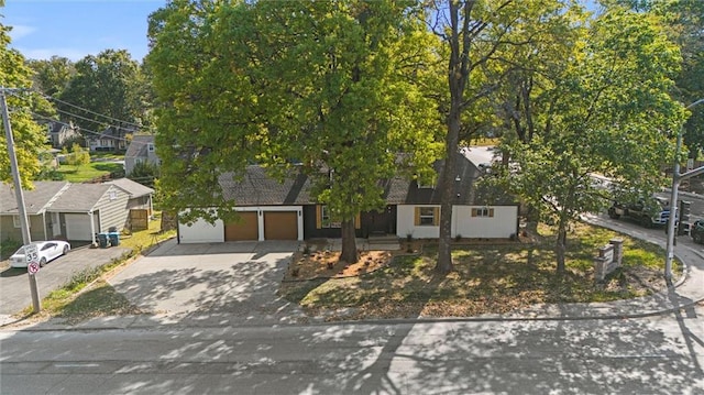 obstructed view of property with a garage