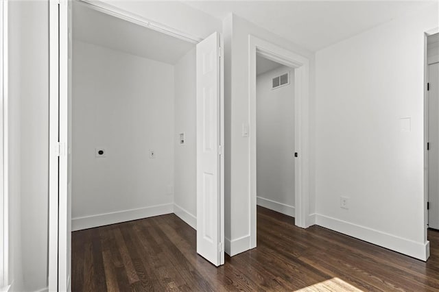 unfurnished bedroom featuring dark hardwood / wood-style floors