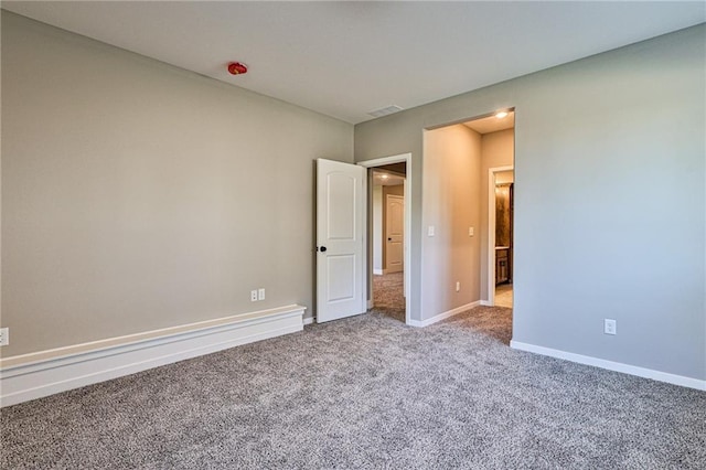 unfurnished bedroom with carpet, baseboards, and visible vents