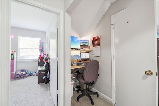 carpeted office with vaulted ceiling