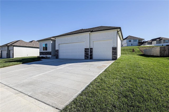 exterior space with a garage, stone siding, a front lawn, and stucco siding