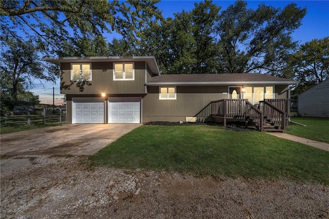 view of front of home with a lawn and a garage