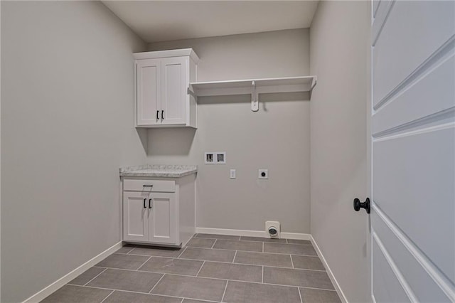 laundry area with light tile patterned floors, hookup for an electric dryer, washer hookup, and cabinets