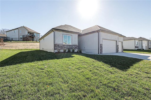 view of front of property with stucco siding, an attached garage, stone siding, driveway, and a front lawn