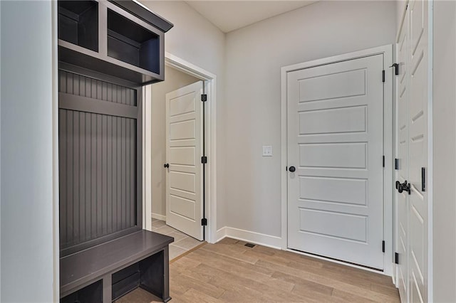 mudroom with light wood-style flooring and baseboards