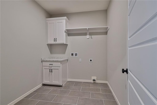 laundry area featuring baseboards, washer hookup, hookup for an electric dryer, and dark tile patterned flooring