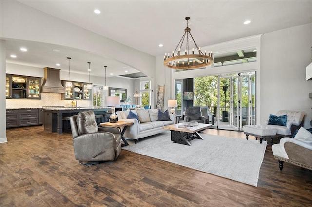 living room with a notable chandelier and dark hardwood / wood-style flooring