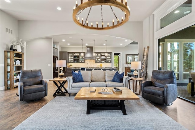 2804 NW Nutall Ct, Lees Summit, MO 64081 - living room with recessed lighting, a chandelier, wood finished floors, arched walkways, and high vaulted ceiling