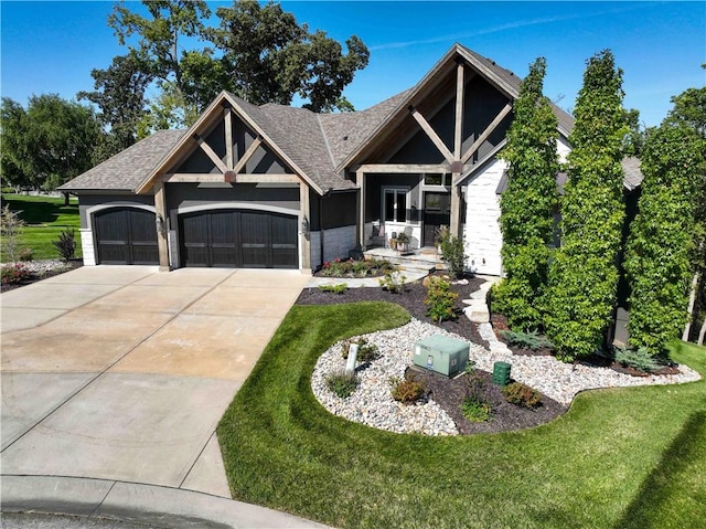 view of front of home with a garage and a front lawn