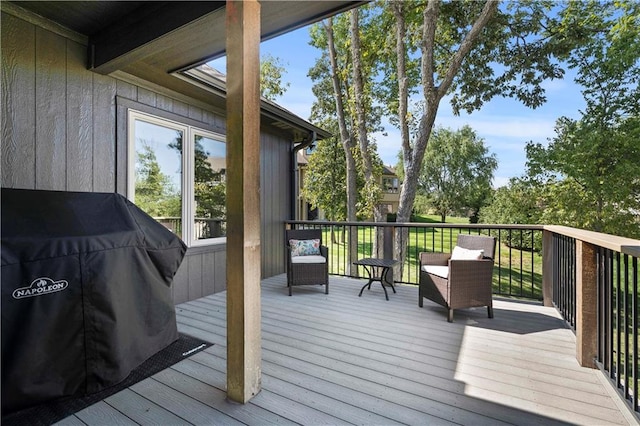 wooden deck featuring a grill