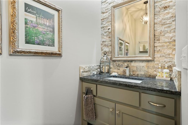 bathroom with vanity and tasteful backsplash