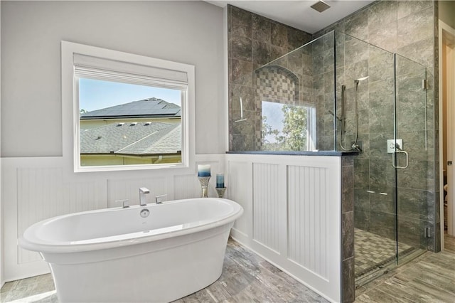 2804 NW Nutall Ct, Lees Summit, MO 64081 - bathroom with a soaking tub, a shower stall, wainscoting, and a decorative wall