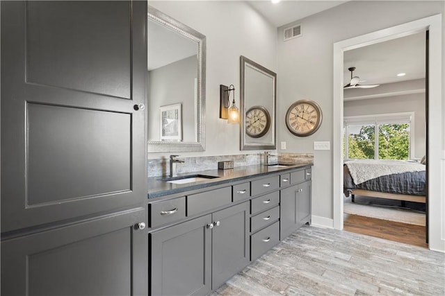 bathroom featuring vanity, hardwood / wood-style floors, and ceiling fan