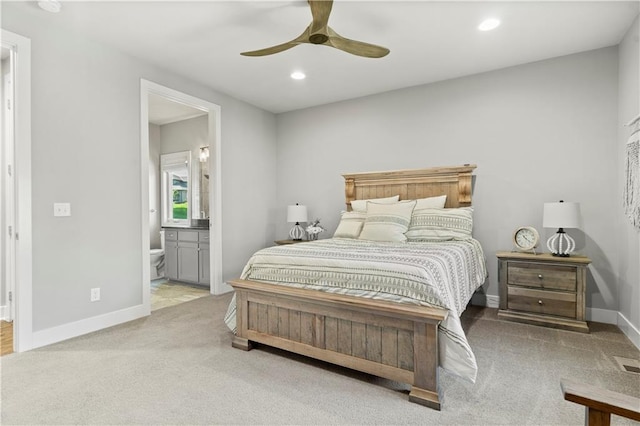 carpeted bedroom featuring ensuite bath and ceiling fan