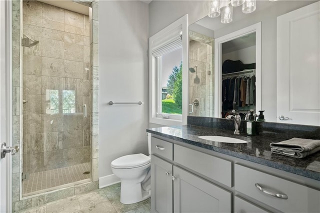 bathroom featuring vanity, toilet, and walk in shower