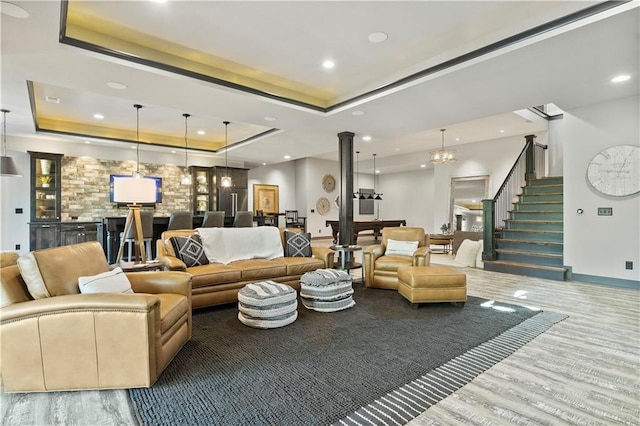 2804 NW Nutall Ct, Lees Summit, MO 64081 - living area featuring a tray ceiling, stairs, wood finished floors, recessed lighting, and bar area