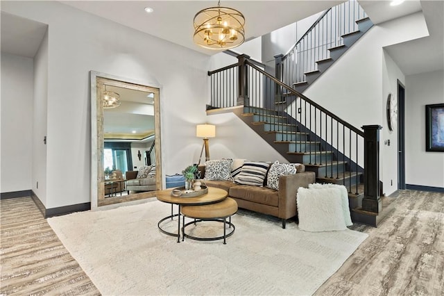 living room with a notable chandelier and hardwood / wood-style flooring