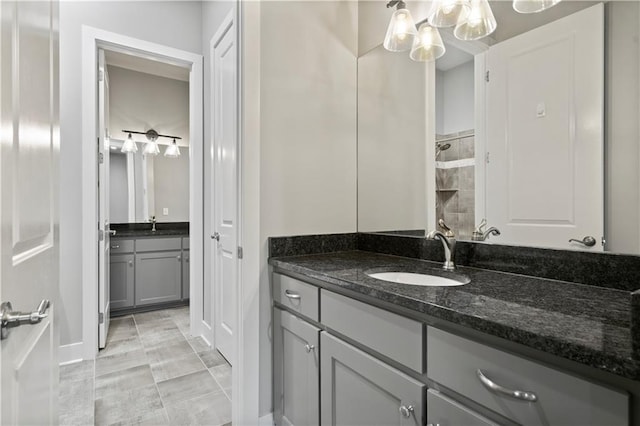 2804 NW Nutall Ct, Lees Summit, MO 64081 - bathroom featuring vanity, a tile shower, and a chandelier