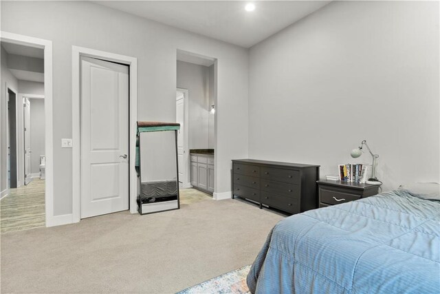 carpeted bedroom featuring ensuite bathroom