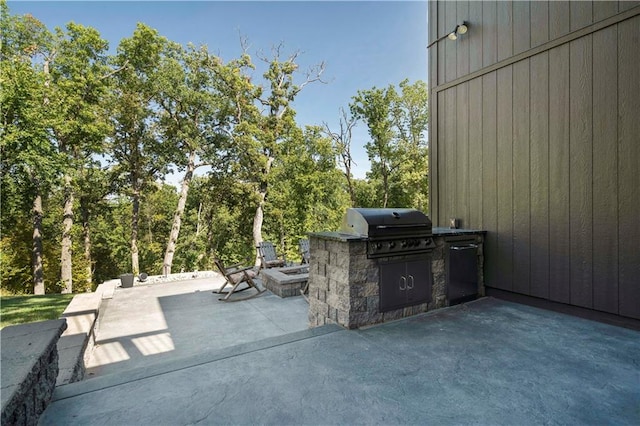 view of patio / terrace featuring area for grilling and a grill