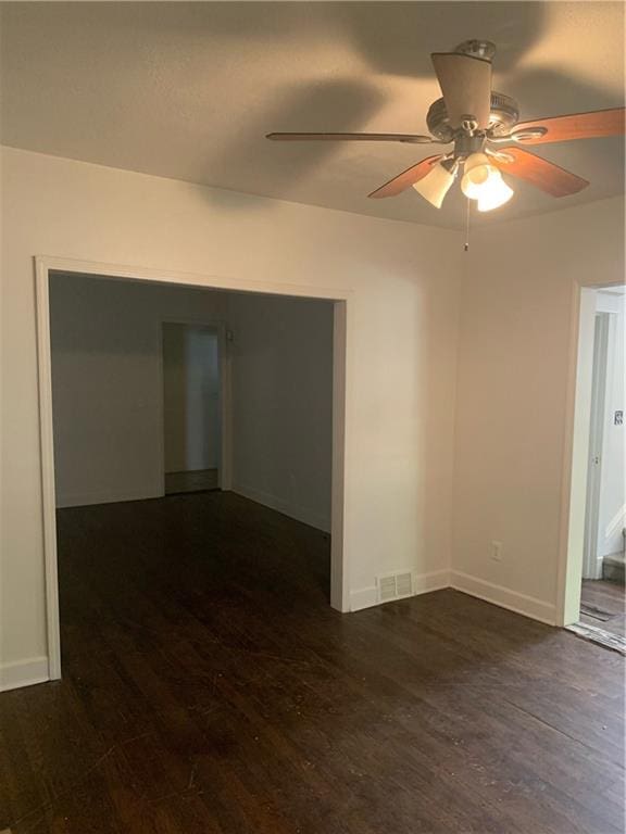 unfurnished room featuring ceiling fan and dark hardwood / wood-style floors