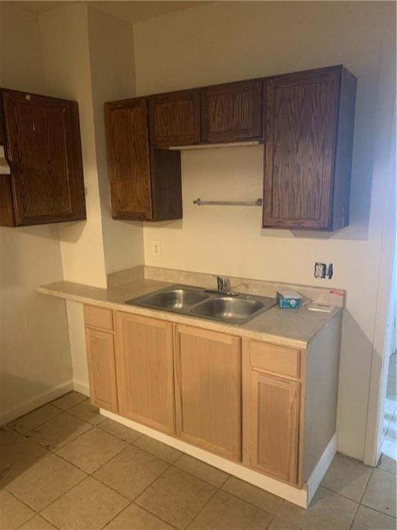 kitchen featuring sink and light tile patterned floors