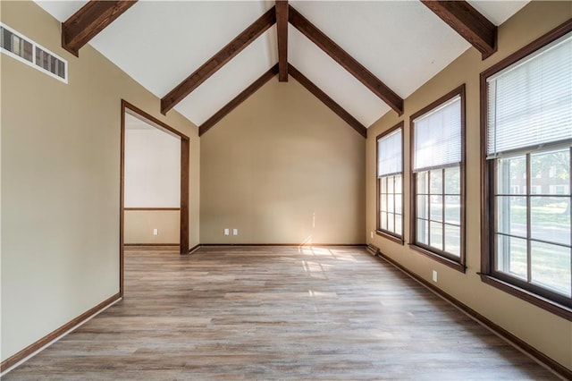 spare room with high vaulted ceiling, light hardwood / wood-style floors, and beamed ceiling