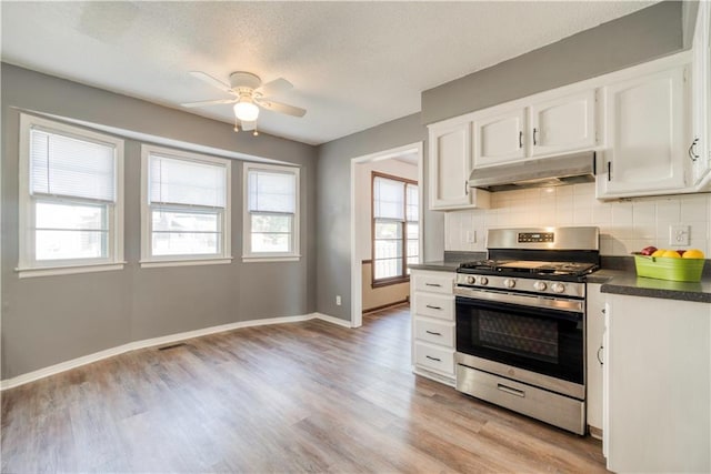 kitchen with white cabinetry, gas range, tasteful backsplash, and light hardwood / wood-style floors