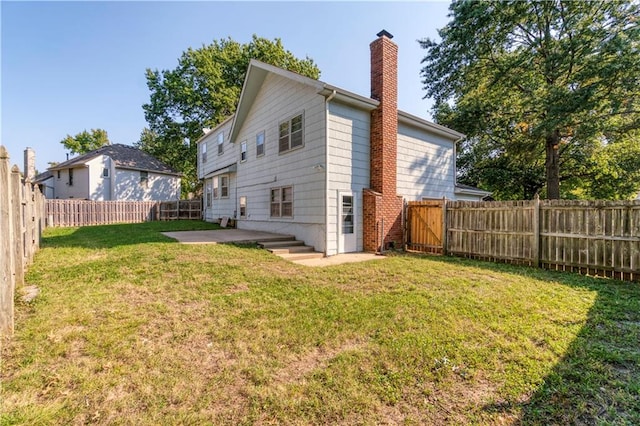 back of house featuring a yard and a patio area