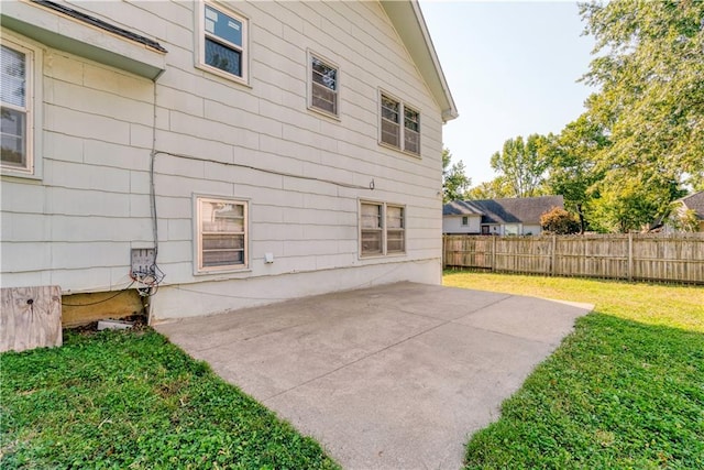 rear view of property with a yard and a patio area