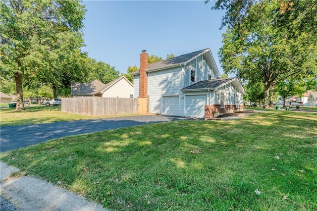 view of property exterior featuring a garage and a yard