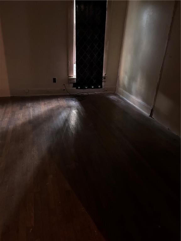 spare room featuring dark wood-type flooring