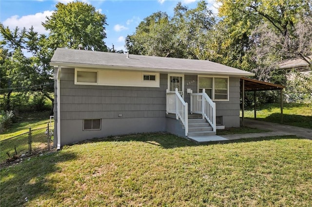 single story home featuring a front lawn and a carport