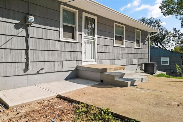 doorway to property featuring central air condition unit and a patio area