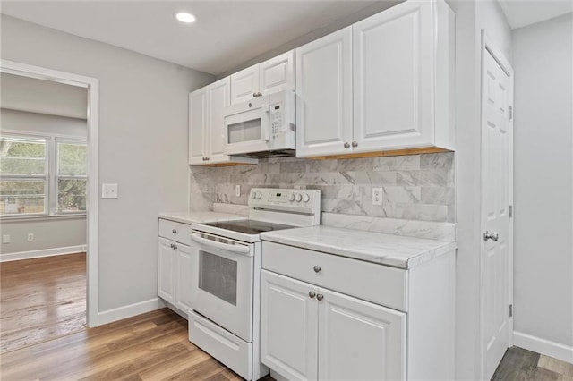 kitchen featuring white cabinetry, light wood-type flooring, and white appliances