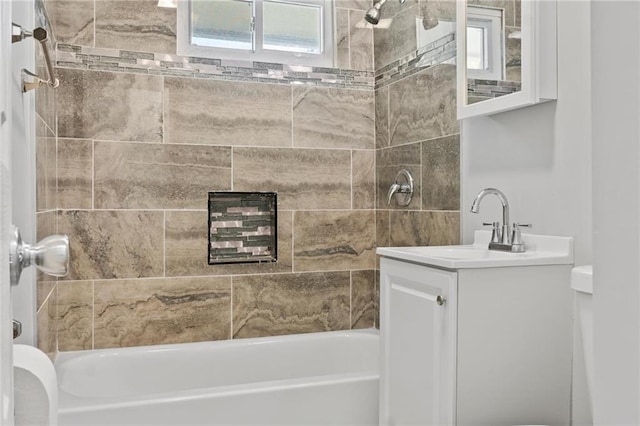 full bathroom with toilet, tiled shower / bath combo, and vanity