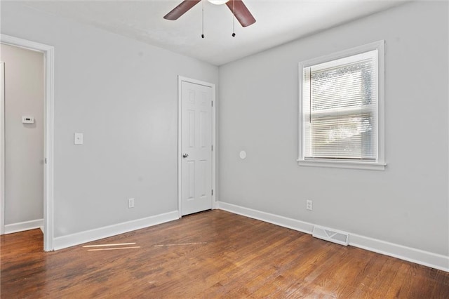 empty room with ceiling fan and wood-type flooring