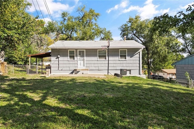 back of property with a lawn and central AC unit