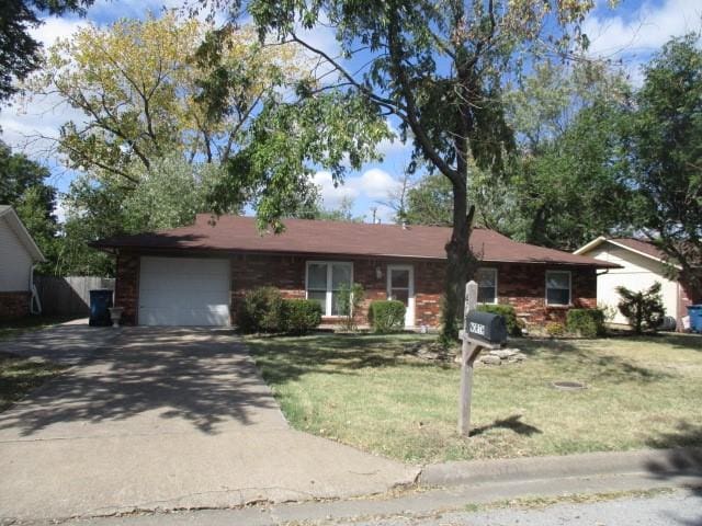 ranch-style house with a front yard and a garage