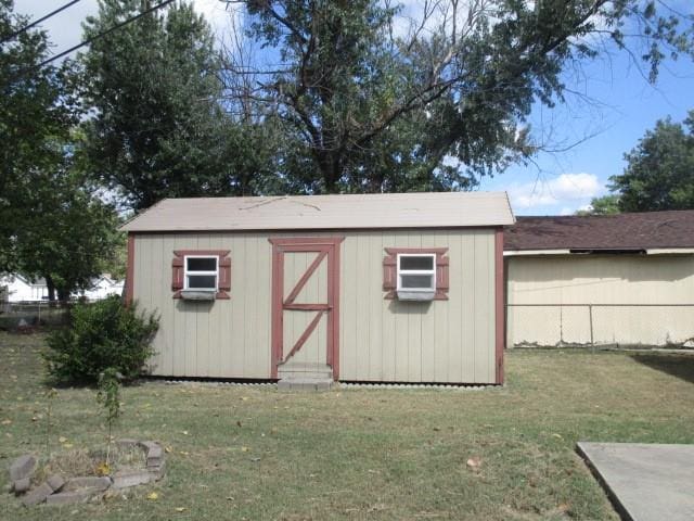 view of outbuilding with a yard