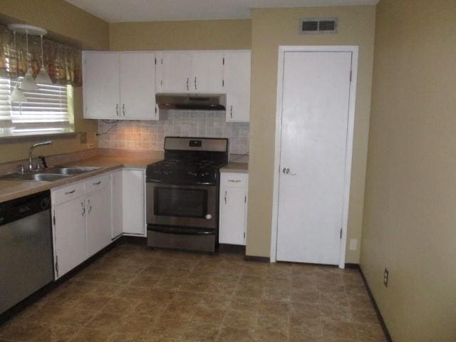 kitchen featuring backsplash, stainless steel appliances, white cabinetry, and sink