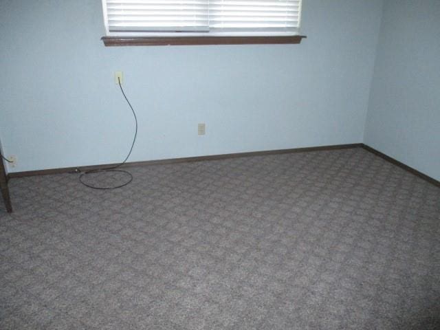 carpeted spare room featuring a healthy amount of sunlight