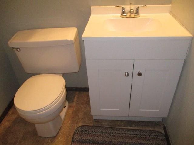 bathroom with tile patterned flooring, vanity, and toilet