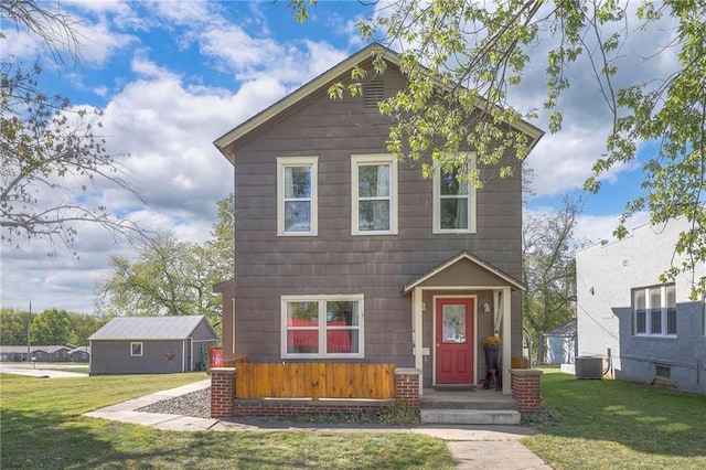 view of front of house featuring a front yard and central AC