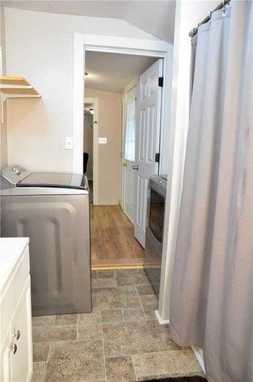 clothes washing area featuring independent washer and dryer and wood-type flooring