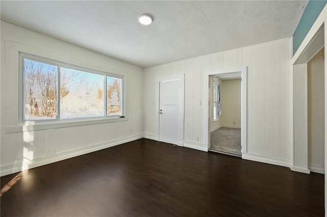 unfurnished bedroom featuring dark wood-type flooring and a closet